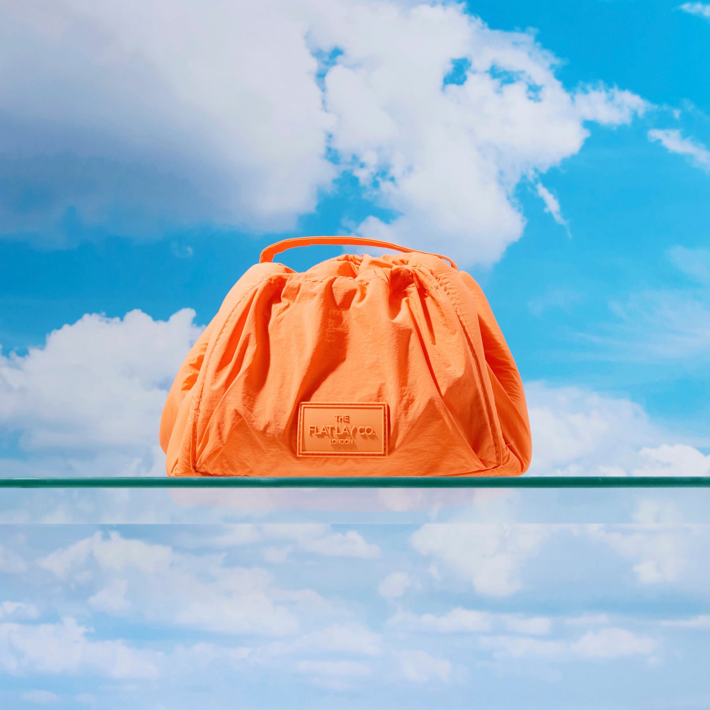 The Flat Lay Co. Drawstring Makeup Bag in Orange Parachute